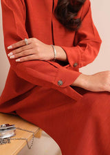 Carnelian rust raw silk suit with subtle pleats and a flowy silhouette