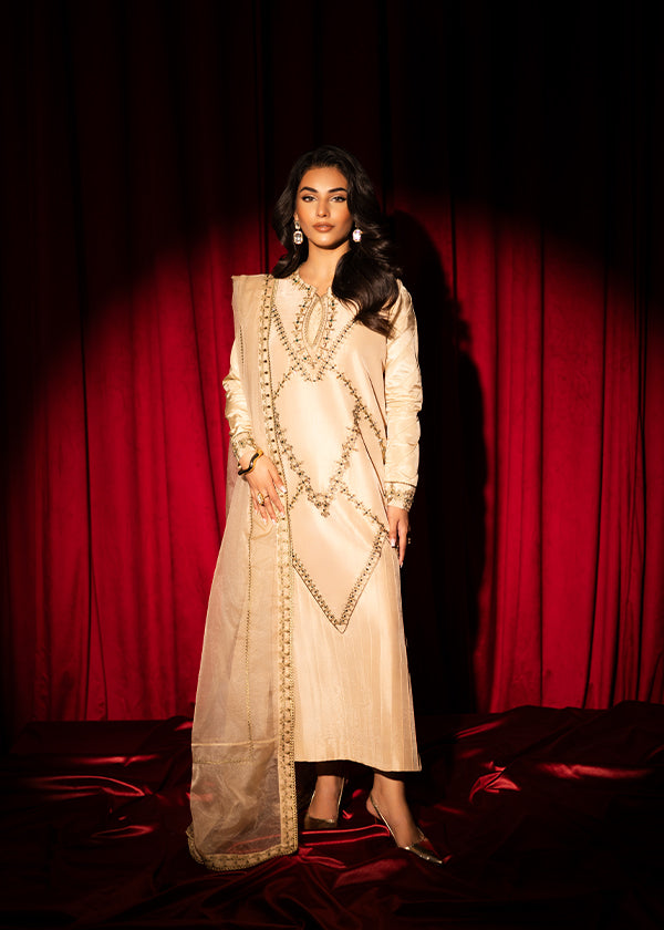 Beige raw silk outfit with emerald embroidery and zardosi detailing.