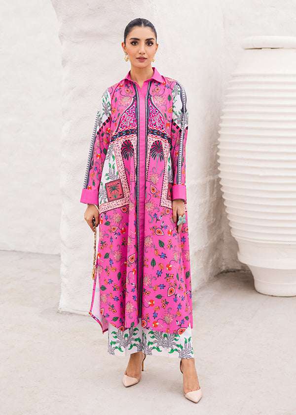 Tropica fuchsia dress with palm tree and floral prints, showcasing a vibrant design and long-line silhouette, paired with loose straight pants for a breezy and chic look.


