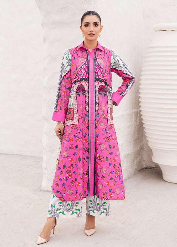 Tropica fuchsia dress with palm tree and floral prints, showcasing a vibrant design and long-line silhouette, paired with loose straight pants for a breezy and chic look.