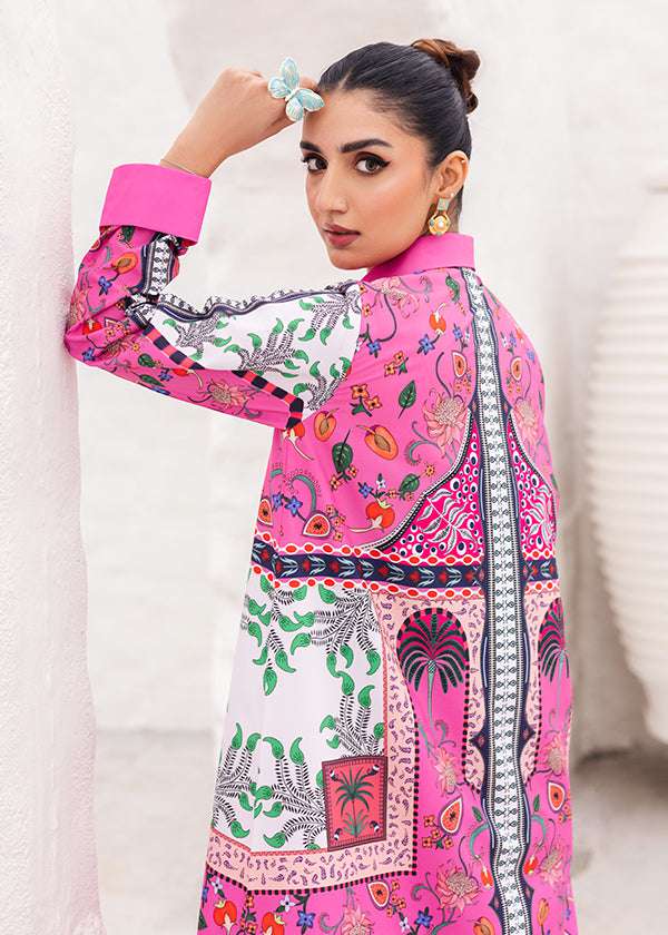 Tropica fuchsia dress with palm tree and floral prints, showcasing a vibrant design and long-line silhouette, paired with loose straight pants for a breezy and chic look.