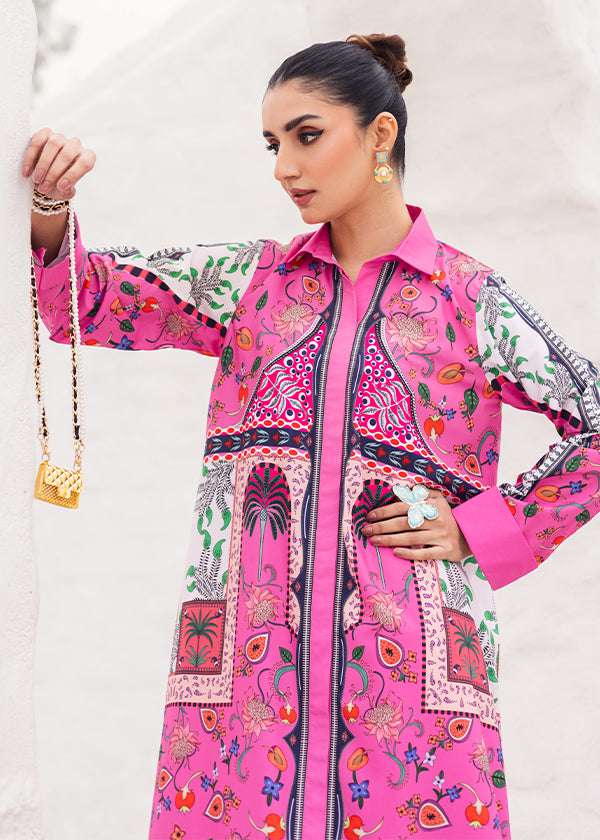 Tropica fuchsia dress with palm tree and floral prints, showcasing a vibrant design and long-line silhouette, paired with loose straight pants for a breezy and chic look.